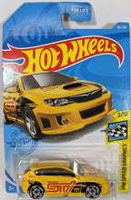 Load image into Gallery viewer, Just in case you didn't know-the WRX stands for World Rally eXperimental. This sporty little car really looks like it has a stiffer suspension and tight handling. Has a sharp white red and black livery with a large graphic STI on the side. Car 2 of 10 in the HW Speed Graphic group. GTB98-M9C0L