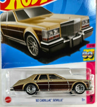 Load image into Gallery viewer, Hot Wheels Metalflake Gold 82 Cadillac Seville 2023
